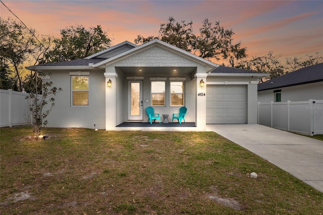 ranch-style house with stucco siding, concrete driveway, a front yard, fence, and a garage