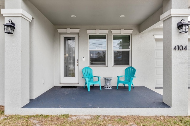 property entrance with stucco siding