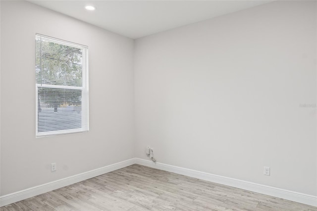 spare room featuring baseboards, recessed lighting, and light wood-style floors