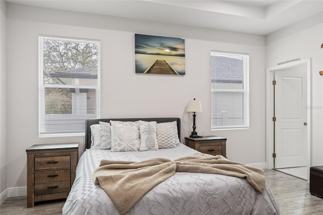 bedroom featuring light wood-style flooring and baseboards