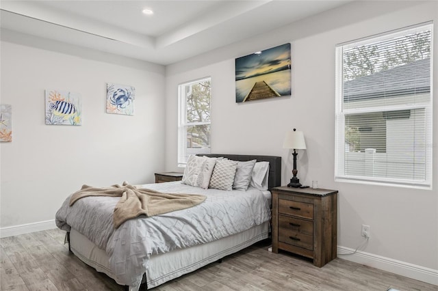 bedroom featuring light wood-style floors, recessed lighting, and baseboards