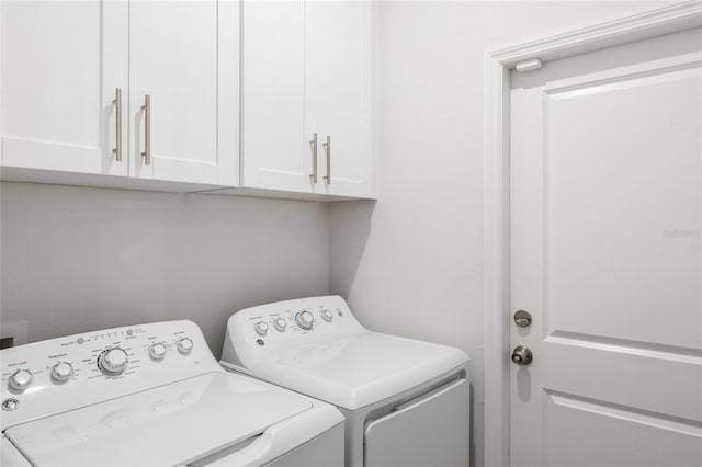 laundry room with washer and dryer and cabinet space