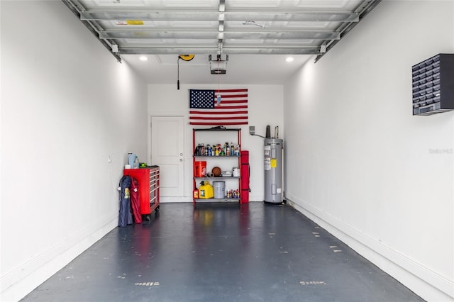 garage with baseboards, a garage door opener, and electric water heater