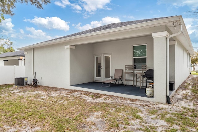 back of property featuring a patio, a lawn, fence, and stucco siding