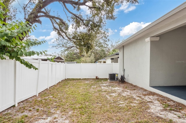 view of yard featuring a fenced backyard and central AC unit