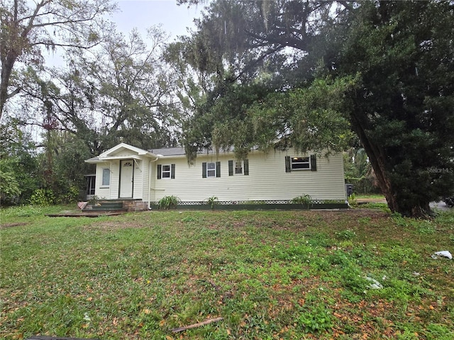 ranch-style home featuring a front yard