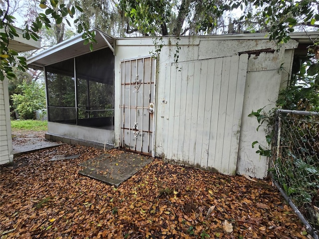 view of outbuilding featuring a sunroom