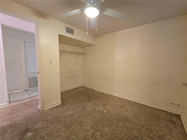 unfurnished bedroom featuring carpet, visible vents, and a ceiling fan