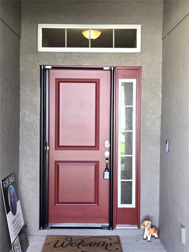 property entrance featuring stucco siding