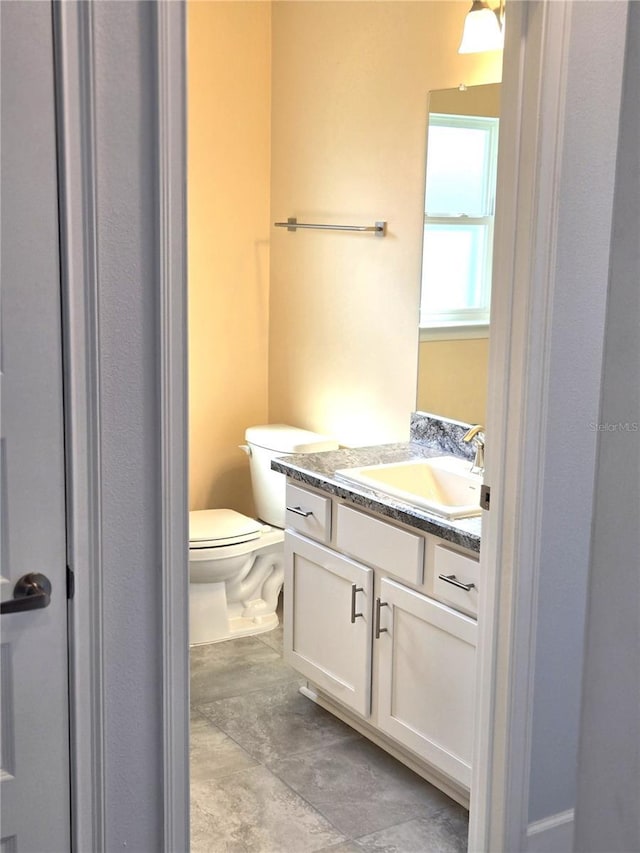 bathroom featuring toilet and vanity