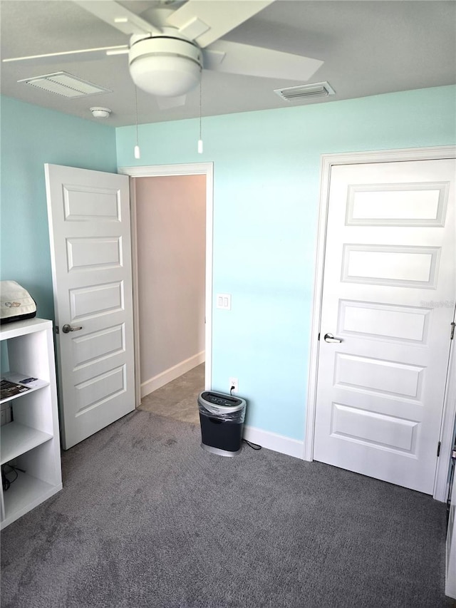 unfurnished bedroom featuring carpet, visible vents, ceiling fan, and baseboards