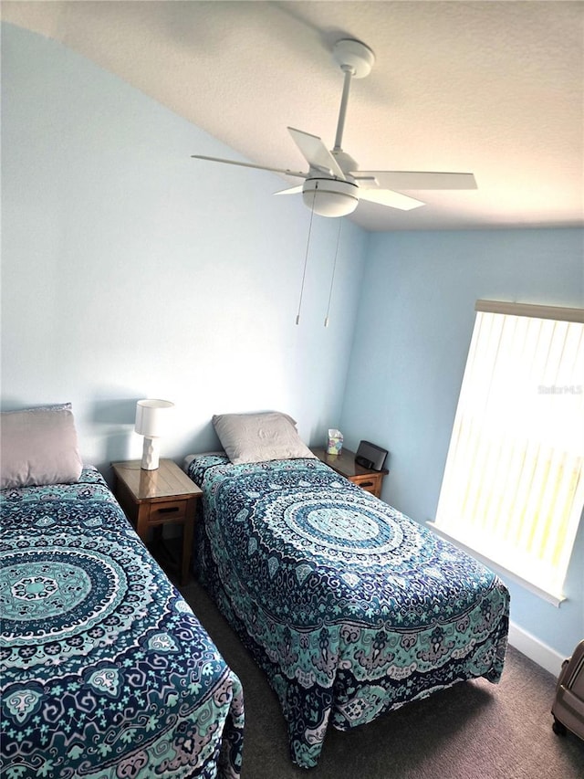 carpeted bedroom featuring a ceiling fan and baseboards