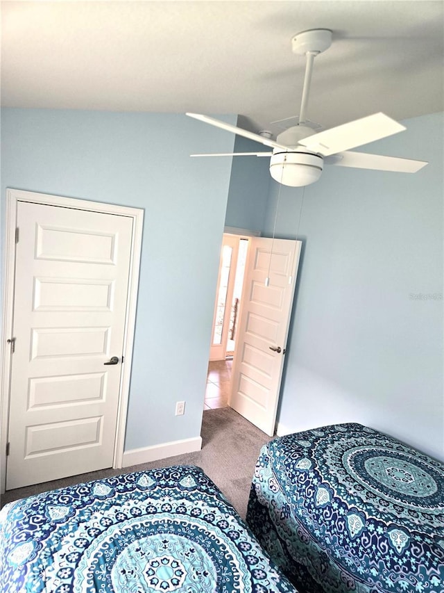 bedroom with carpet floors, a ceiling fan, and baseboards