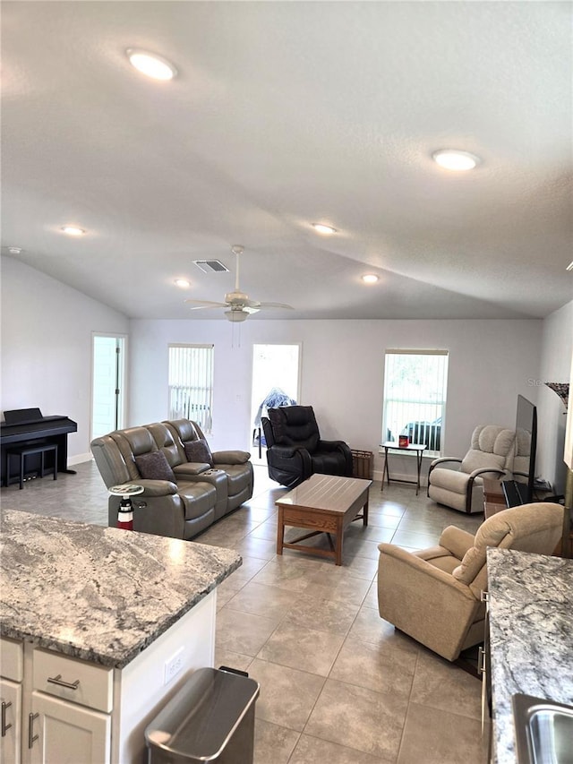 living room featuring light tile patterned floors, recessed lighting, visible vents, a ceiling fan, and vaulted ceiling