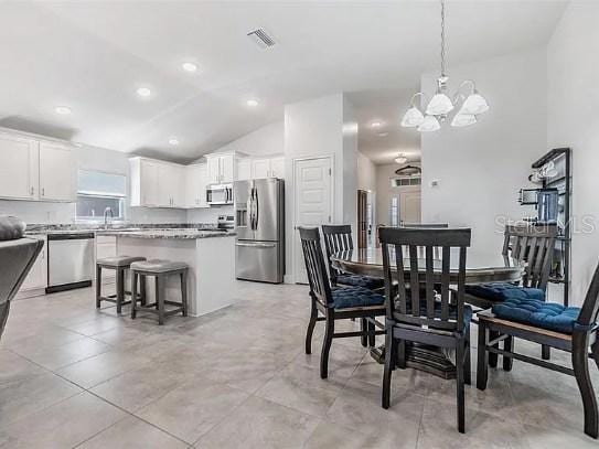 dining space featuring high vaulted ceiling, recessed lighting, visible vents, and an inviting chandelier