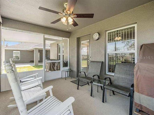 sunroom with ceiling fan