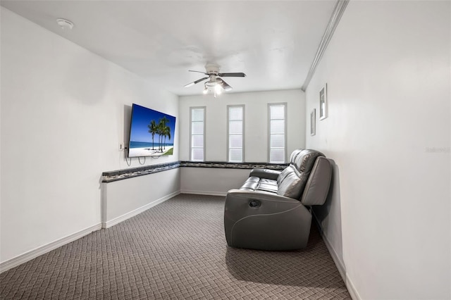 sitting room featuring ceiling fan, ornamental molding, carpet flooring, and baseboards