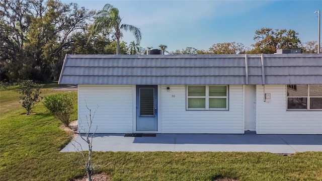 back of property with a patio area and a yard