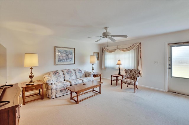 living room featuring a ceiling fan, carpet flooring, and baseboards