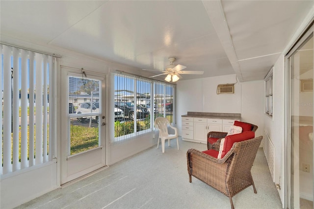 sunroom featuring ceiling fan and a wall mounted AC