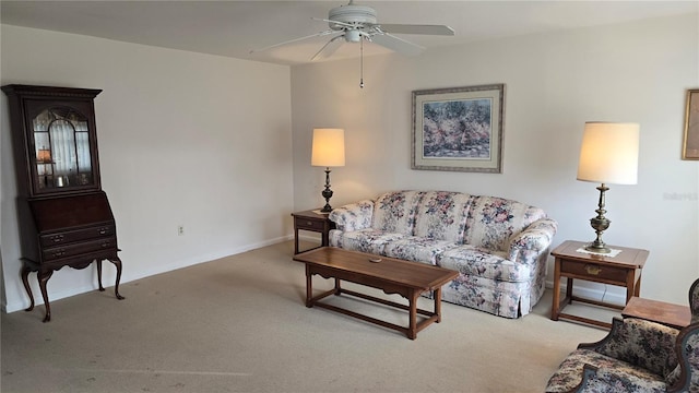 living area with a ceiling fan, carpet flooring, and baseboards