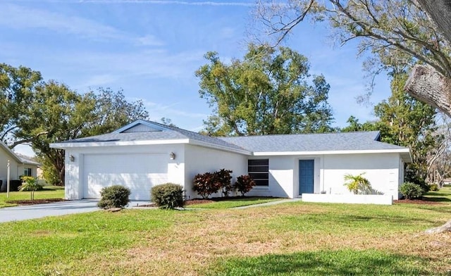 ranch-style home with a garage, driveway, a front yard, and stucco siding