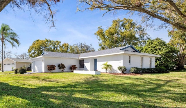 single story home featuring an attached garage, a front lawn, and stucco siding