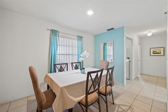 dining room featuring light tile patterned flooring and visible vents