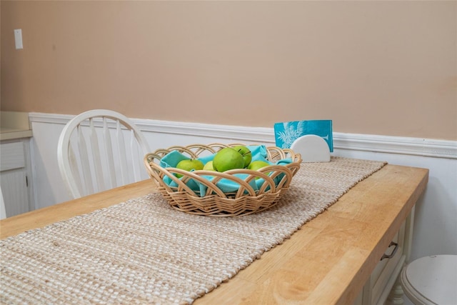 interior space with a wainscoted wall