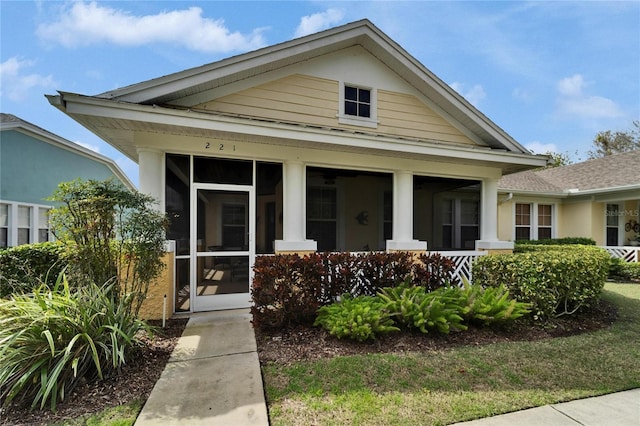 view of front facade with a sunroom