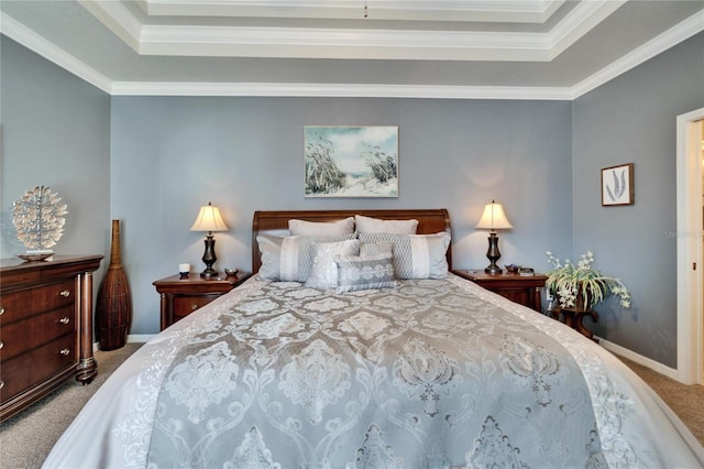 bedroom with carpet floors, baseboards, and a tray ceiling