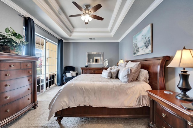 bedroom with ceiling fan, light carpet, visible vents, a raised ceiling, and crown molding