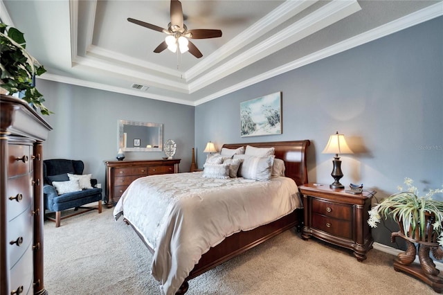 bedroom featuring crown molding, a raised ceiling, light colored carpet, visible vents, and a ceiling fan