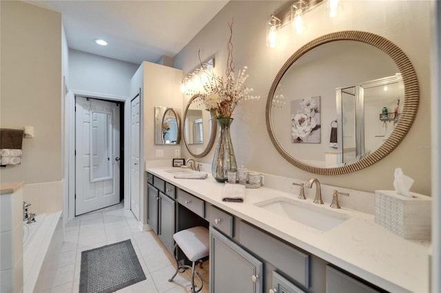 full bathroom with double vanity, a sink, a bath, and tile patterned floors