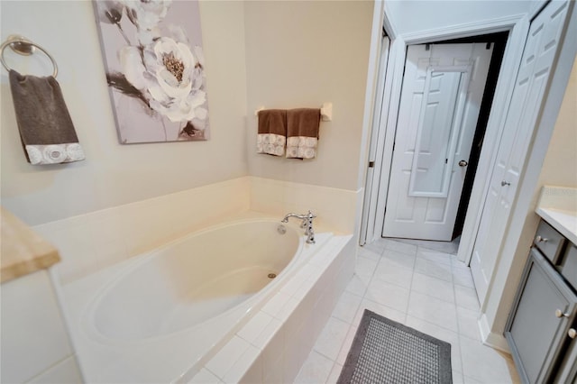 bathroom with tile patterned floors, a closet, vanity, and a bath