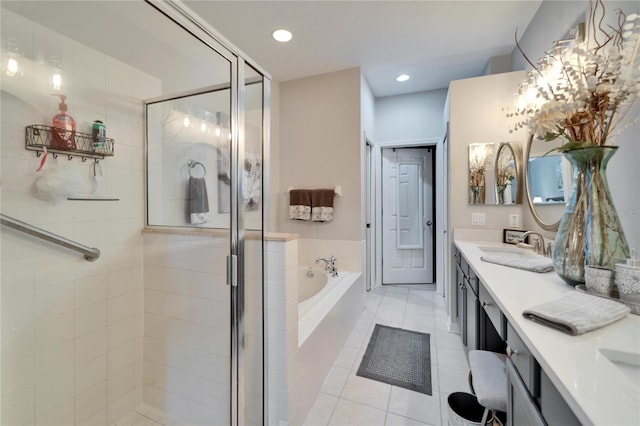 full bath featuring tile patterned flooring, vanity, a shower stall, a bath, and recessed lighting