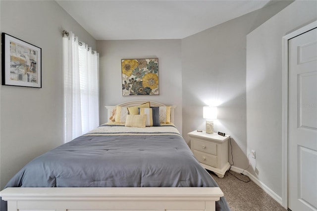 bedroom featuring carpet and baseboards