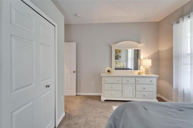 bedroom with light carpet and baseboards