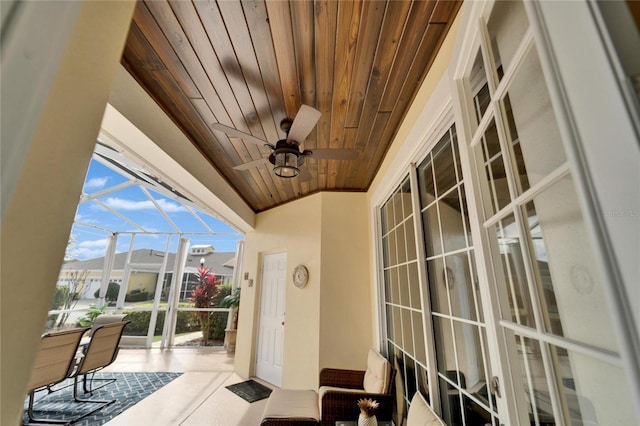 balcony featuring a sunroom, ceiling fan, and a patio