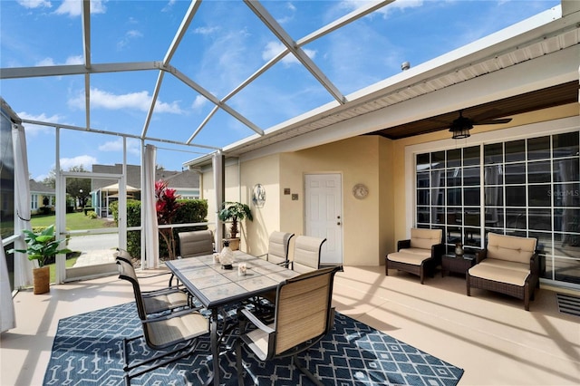 view of patio / terrace with a lanai, ceiling fan, an outdoor hangout area, and outdoor dining area