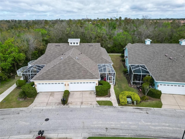 birds eye view of property featuring a wooded view