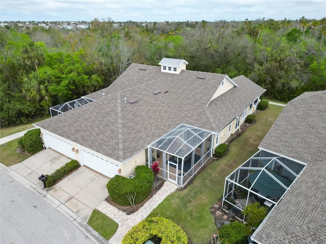 birds eye view of property with a wooded view