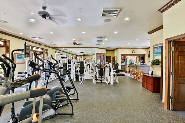 exercise room with visible vents, ornamental molding, and recessed lighting