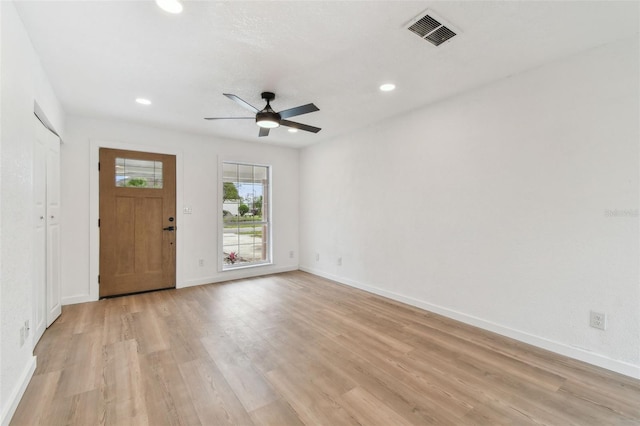 interior space featuring recessed lighting, a ceiling fan, baseboards, visible vents, and light wood finished floors