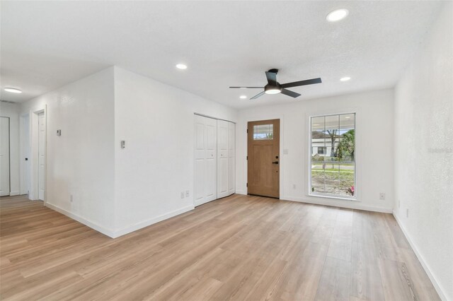 entryway with light wood-type flooring, baseboards, and recessed lighting