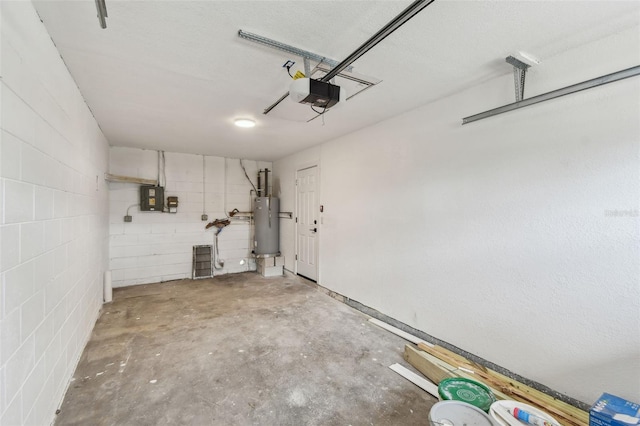 garage featuring a garage door opener, concrete block wall, gas water heater, and electric panel