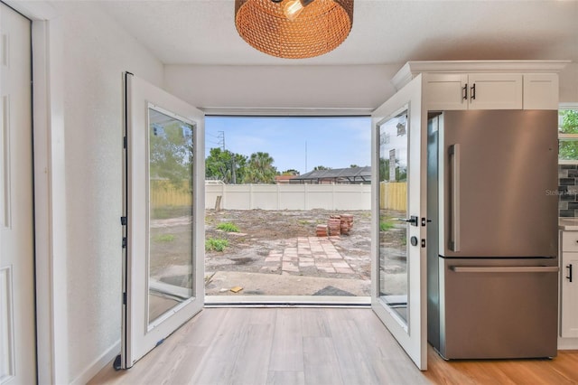 doorway to outside featuring light wood-type flooring