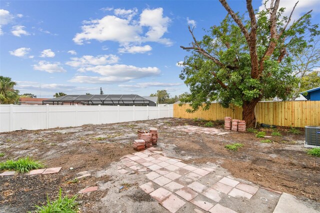 view of yard featuring central AC, a patio, and a fenced backyard