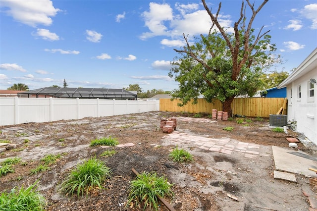 view of yard featuring a fenced backyard and central AC unit