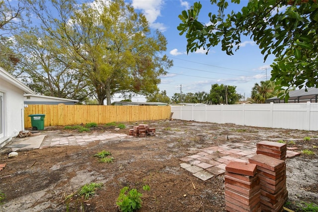 view of yard featuring a patio and a fenced backyard